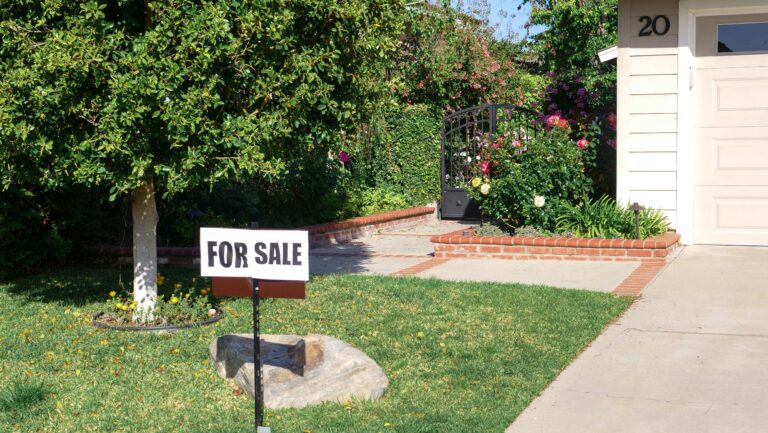 for sale sign in front yard representing the cost to sell a house in Oklahoma
