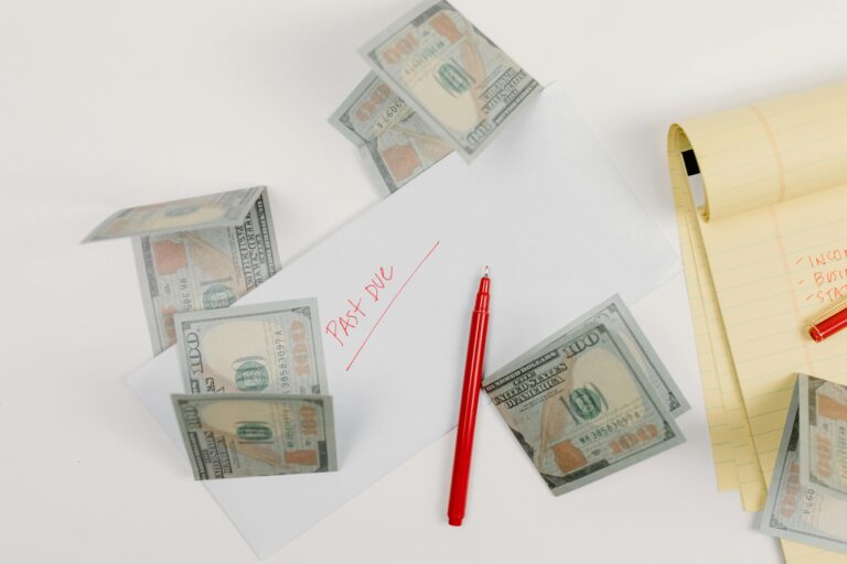 calculator and financial paperwork representing debt to income ratio for buying a house in Oklahoma