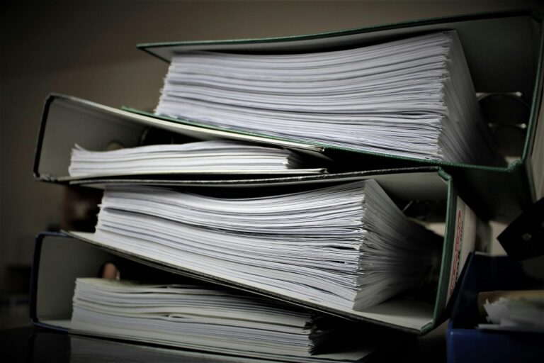 real estate paperwork and contract documents representing documents needed to sell a house in Oklahoma