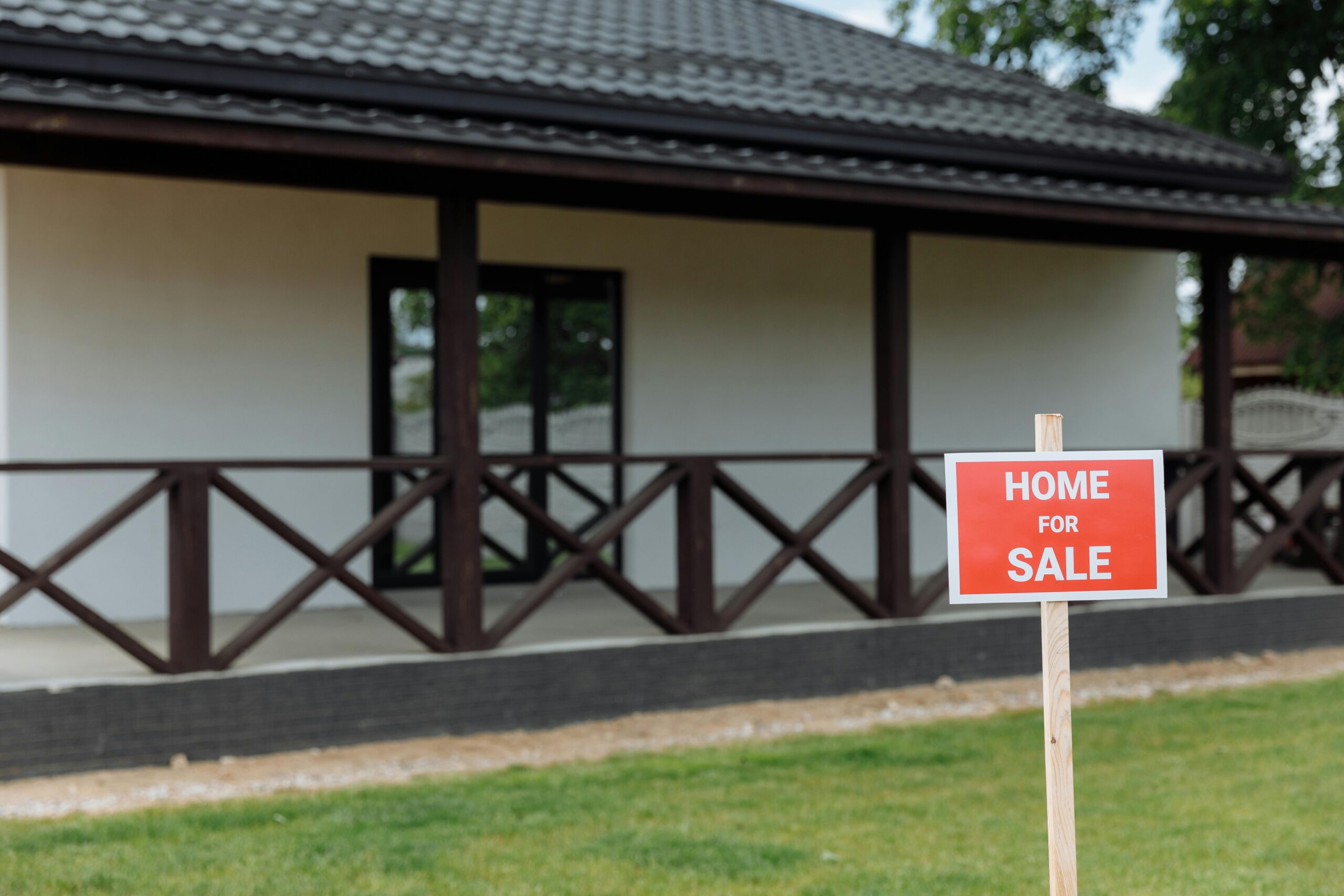 home for sale sign in front of house representing selling a house fast in Oklahoma